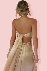 Detail view of a sexy solid color halter strapless top and skirt two-piece set with gold chains.