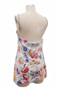 Detail view of backless sequin floral mini dress with metallic chain straps and colorful embroidery.