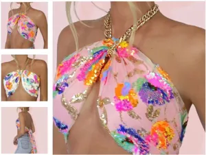 Close-up detail of the colorful sequin embroidery and chunky gold chain halter strap.