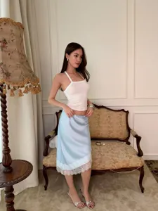 Slim fit light blue satin midi skirt featuring delicate white lace trim and elegant style.