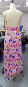 Pink sequin floral long dress with gold chain straps and backless design for women.
