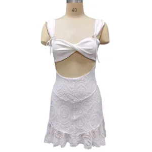 White lace cutout crop top and mini skirt set detail view, stylish twist front design.