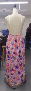 Detailed view of the pink sequin floral embroidered long dress on mannequin in workshop
