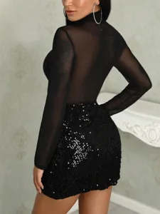 Close up view of sexy black sheer long sleeve top paired with shiny sequin bodycon skirt.
