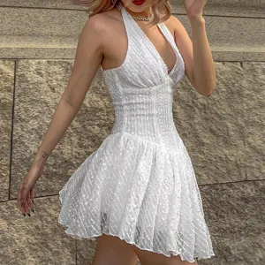 Sexy white halter V-neck backless mini dress with textured fabric for stylish summer party look.