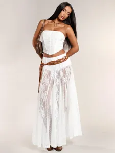 Detailed shot of white strapless corset top and lace spliced long skirt set for women.