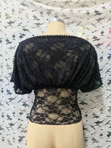Black lace hollow-out top detail view, showing delicate floral lace texture and short sleeves.