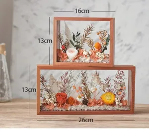 Detailed view of 3D wooden hollow photo frame with dried preserved flowers for DIY home decor.