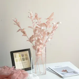 Detailed view of pink preserved leaves dry flower bouquet in clear vase for home decor.