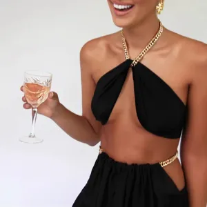 Women sexy black halter two piece set featuring gold chain crop top and matching skirt outfit