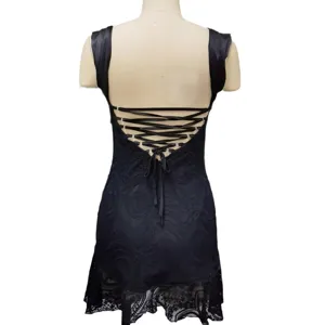 Back detail view of the sexy black lace mini dress with lace-up straps and pattern.
