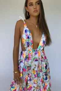 Detailed view of the sparkling sequin floral deep V long dress with open back and slit.