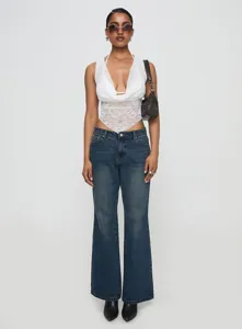 Summer sexy white lace halter v-neck sleeveless tank top paired with stylish blue denim jeans.