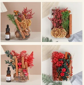 Detalles en primer plano de ramitas de canela, flores secas, piñas y frasco de aceite esencial.