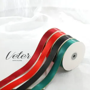 Detailed view of 2.5cm double gold edge satin ribbon rolls in various colors for gifts.