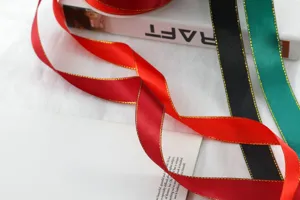 Detail shot of 2.5cm double gold edge satin ribbon, perfect for gift wrapping and crafting.