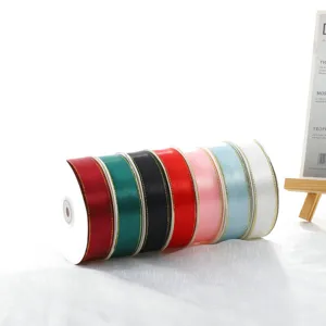 Close-up of colorful ribbon rolls with delicate double gold edges, smooth satin material.