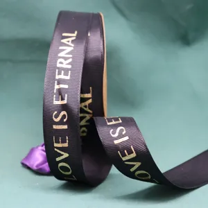 Black ribbed ribbon detail featuring gold foil stamped lettering for floral gift wrapping