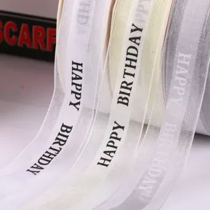Close-up detail of 2.5cm Happy Birthday printed ribbon rolls for gift wrapping decoration.