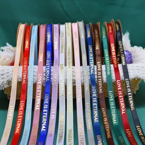 Close-up detail of colorful 1cm ribbon with gold stamping text for gift wrapping and floral design