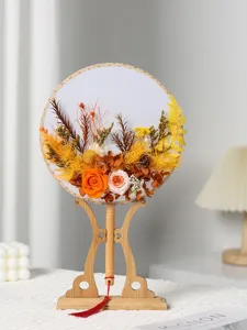 Vista dettagliata di ventaglio rotondo in fiori secchi stile cinese con supporto in legno.