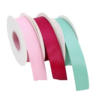 Matte satin polyester cotton ribbon rolls in three colors, ideal for gift and bouquet wrap.