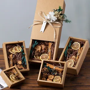 Rustic kraft paper gift box set with dried flowers, pinecones, and cinnamon for birthday.