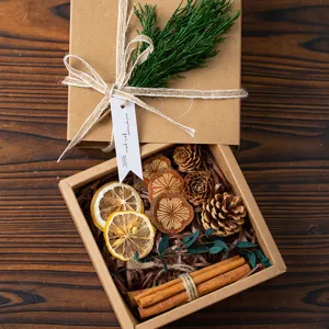 Rustic kraft paper gift box filled with natural dried pine cones and sweet cinnamon.