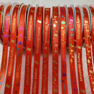 Christmas red ribbon with gold printed merry christmas letters and festive holiday patterns.