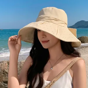 Beige wide brim sun hat detail view, featuring delicate bowknot and rhinestones design.