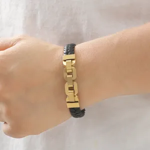 Macro view of men's braided leather bracelet with gold-tone titanium steel links