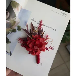 Red preserved flower wedding boutonniere detail shot, elegant romantic floral accessory for groom.