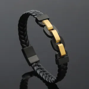 Close-up of black braided leather men's bracelet with gold stainless steel links