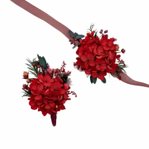 Red preserved flower corsage and wrist flower set for wedding bride and groom decor.
