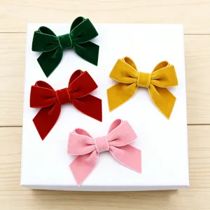 Velvet bow hair clips in four vibrant colors, smooth flocking texture for lovely hairstyles.