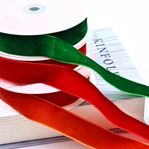 Detail shot of colorful velvet ribbons rolled on spools, showing soft texture and fine craft.