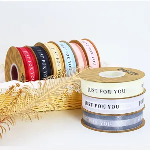 Detail view of colorful fabric ribbons with printed just for you text for gift wrapping crafts