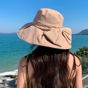 Stylish rhinestone bow bucket hat for women summer beach vacation wide brim sun protection.