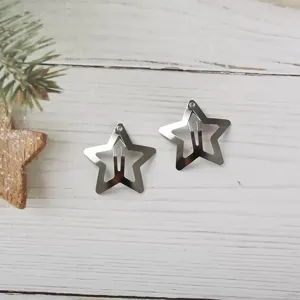 Close-up of silver metal star hair clips, Y2K aesthetic, sleek daily hairpin details.