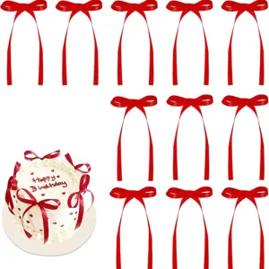 Red ribbon bows detail shot, decorative bows for cake and party celebration setups.