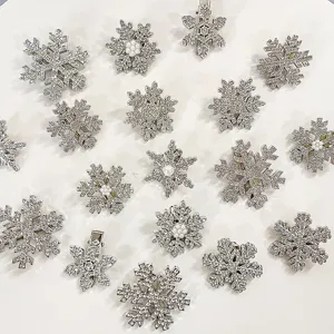 Detailed view of exquisite snowflake hair clips, sparkling rhinestones with pearls.