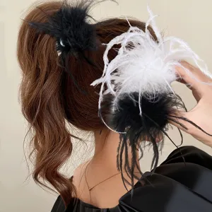 Detail view of fluffy feather hair claw clip, elegant half-up hairstyle accessory design.