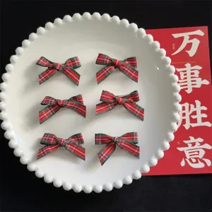 Detailed shot of cute preppy plaid hair bow clips in red and green, charming accessories.