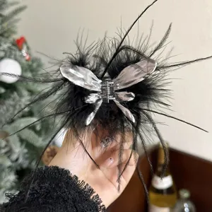 Black feather hair claw clip with silver liquid butterfly design, stylish and trendy hair accessory.