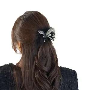 Trendy liquid butterfly hair claw clip with black feathers, chic and elegant hair accessory for women.