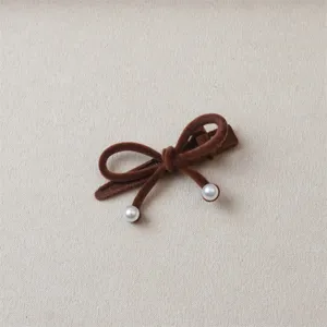 Brown velvet bow hair clip detail shot, featuring delicate pearl pendants for sweet styling.