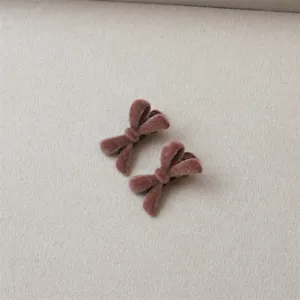 Velvet bow hair clip detailed view, cute pink plush hair accessory for daily sweet styling.