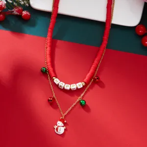 Close-up detail of festive Christmas layered necklace with snowman and HAPPY beads
