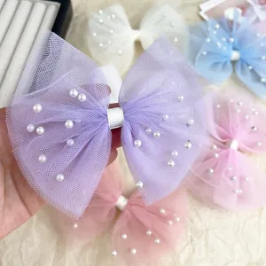 Close up detail of mesh pearl bow hairpin with elegant design for kids hair accessories