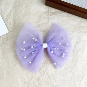 Detail view of the elegant lavender mesh pearl bow hair clip, delicate design for girls and women.